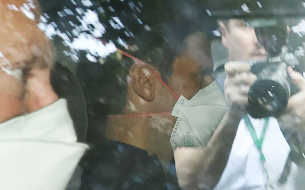 Novak Djokovic wears a face mask as he arrives at the lawyer's office in Melbourne on 16 January 2022.