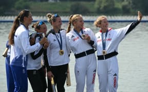 Silver medallists Romania's Ancuta Bodnar and Simona Radis, New Zealand's gold medallists Brooke Francis and Lucy Spoors, and bronze medallists Britain's Mathilda Hodgkins Byrne and Rebecca Wilde pose for a selfie photo on the podium during the medal ceremony after the women's double sculls final rowing competition at Vaires-sur-Marne Nautical Centre in Vaires-sur-Marne during the Paris 2024 Olympic Games on August 1, 2024. (Photo by Bertrand GUAY / AFP)