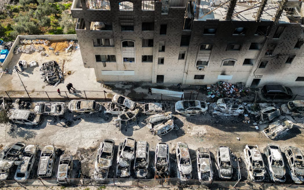 This picture taken on February 27, 2023 shows an aerial view of a scrapyard where cars were torched overnight, in the Palestinian town of Huwara near Nablus in the occupied West Bank.