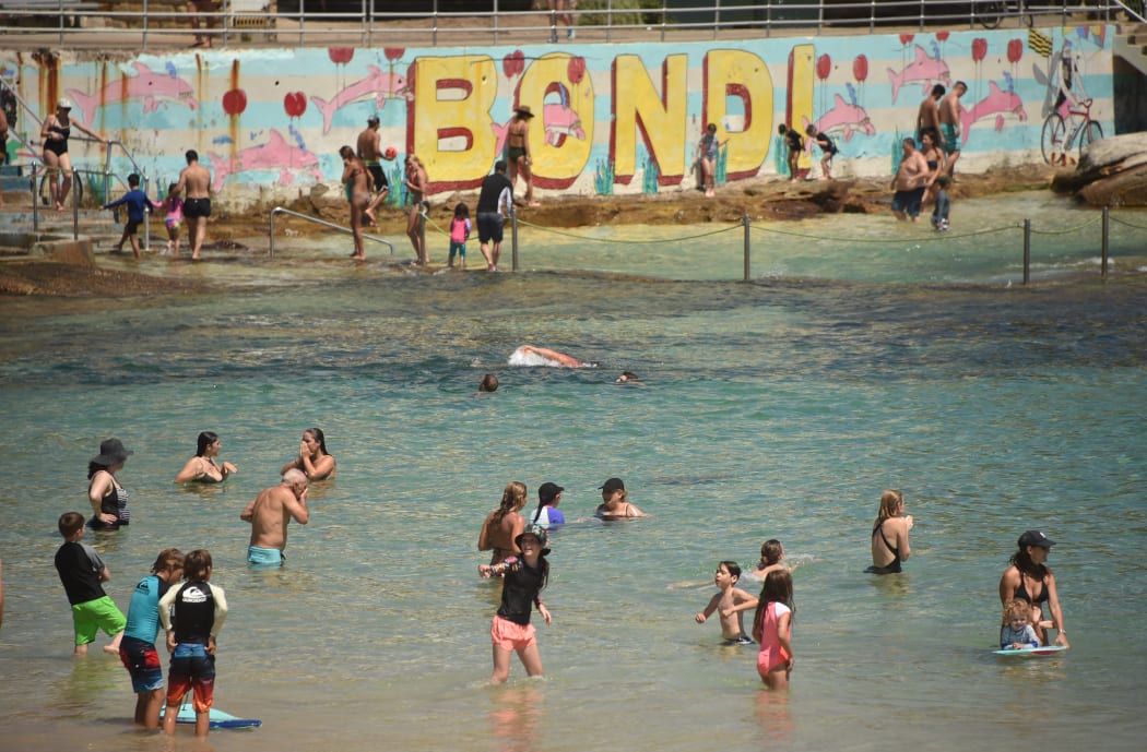 Sunbathers cool off on Bondi Beach as temperatures soar during a heatwave in Sydney on December 28, 2018.
