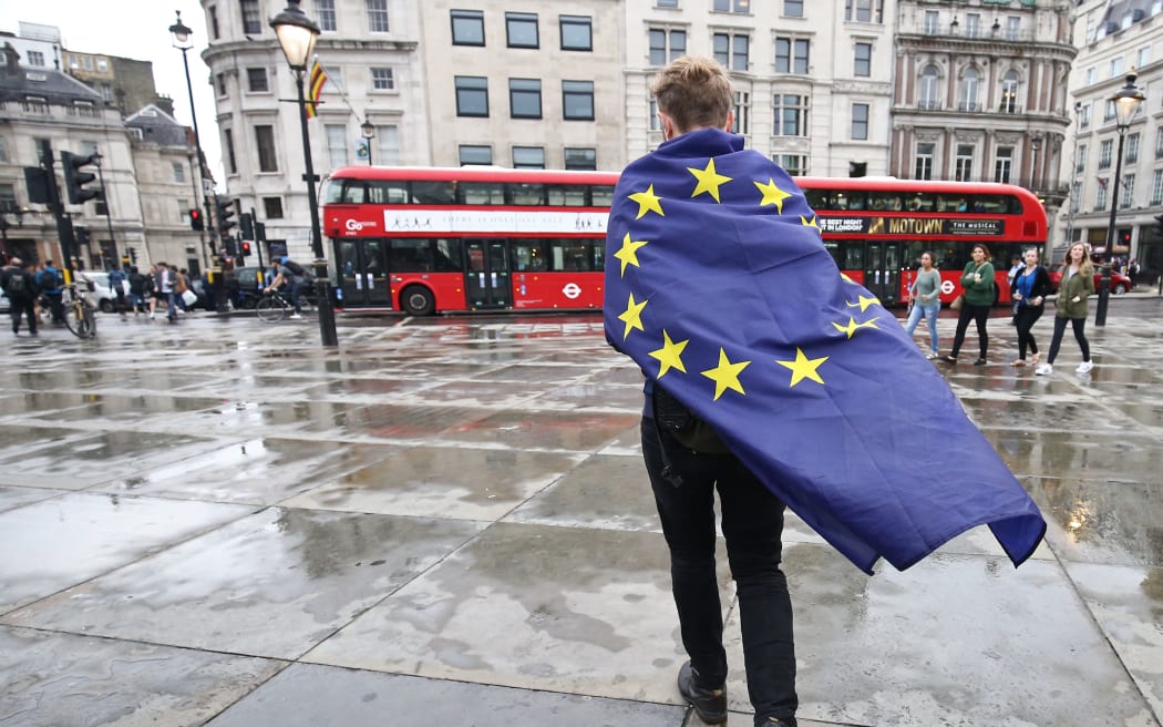 A demonstrator wrapped in a European flag leaves an anti-Brexit protest in Trafalgar Square in central London, 28 June 20016.