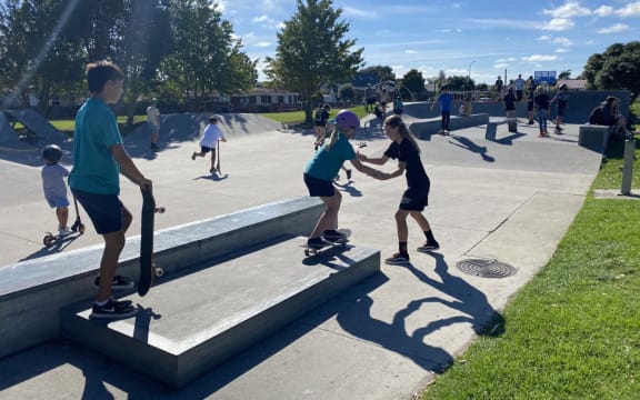 Children learning to skateboard.