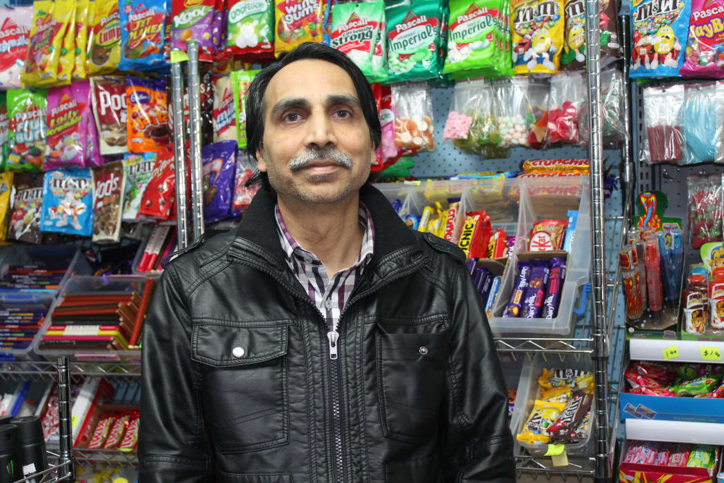 A photo of Kamlesh Patel in front of the sweet selection in his Opawa dairy. His shop has been robbed four times in seven years