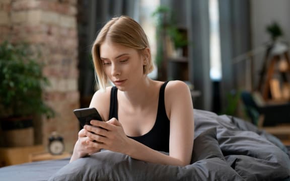 Woman on a cellphone cancelling plans.