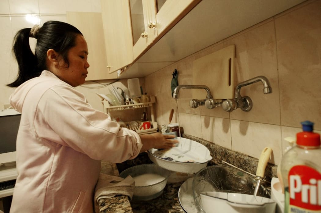 A house maid from Philippines washes the dishes at her employers' apartment in the Lebanese capital Beirut.