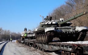 Footage released by Moscow on 16 February 2022 shows Russian soldiers loading tanks and military equipment on to railway platforms after a drill near Ukraine.