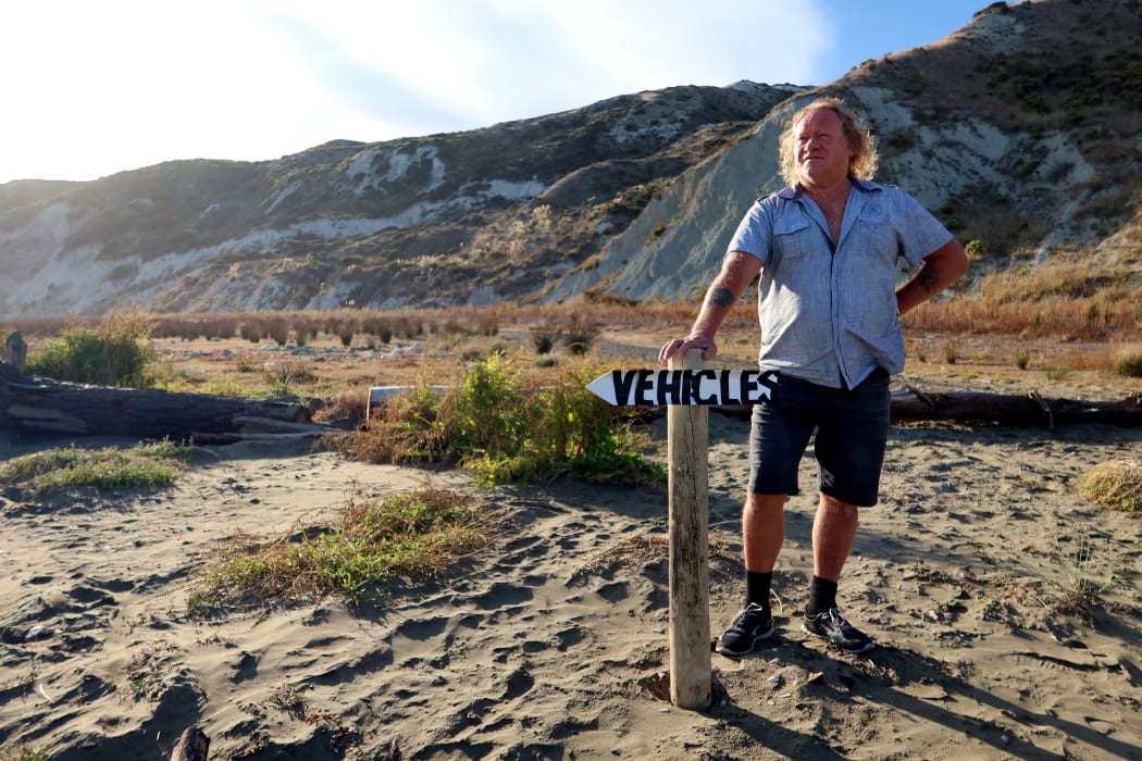 Fisherman Mark Wills, who is leading the charge against a proposed quad bike ban, stands in front of a log barricade at Marfells Beach, Marlborough.