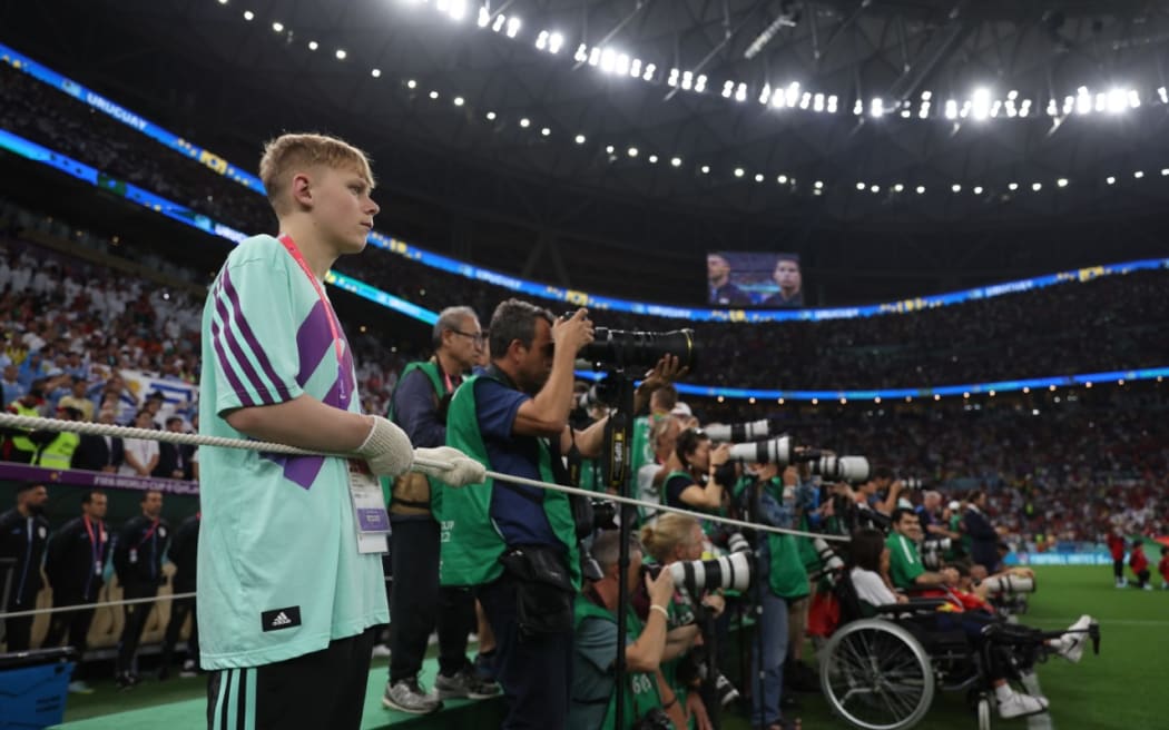 FIFA volunteer Daniel Lammers holds the photographers at bay at Lusail Stadium.