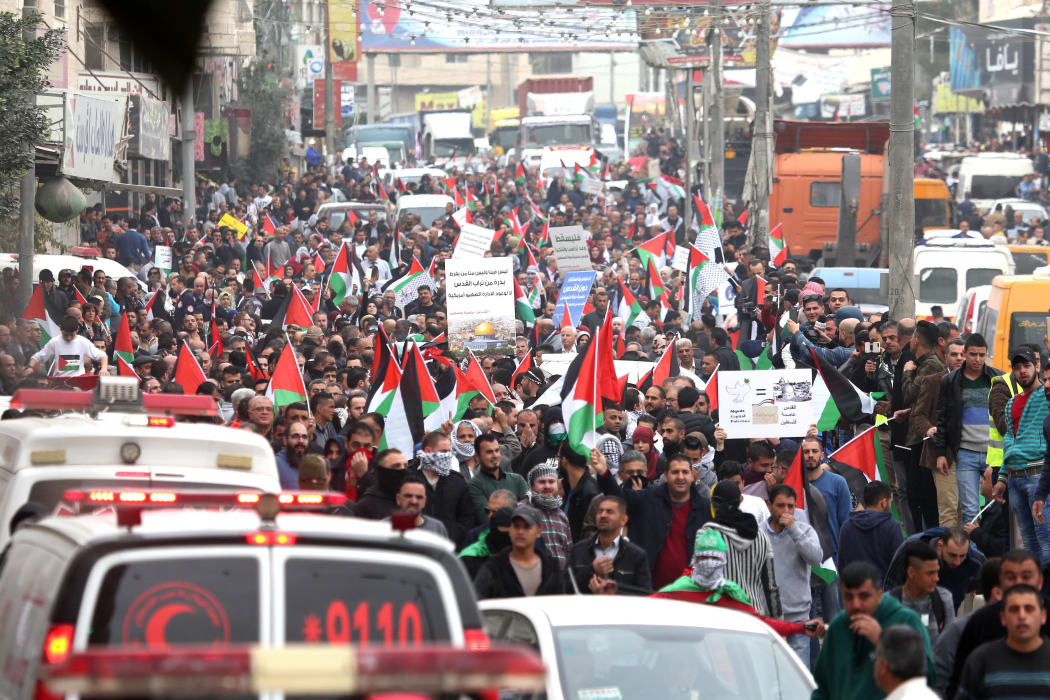 Palestinians stage a demonstration against US President Donald Trump's recognition of Jerusalem as Israel's capital, near the Kalandia check point in Ramallah, West Bank, on Wednesday.