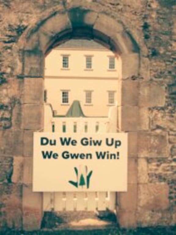 Norfolk Island. Archway into OMB...slogan reads "Don't give up We will win"