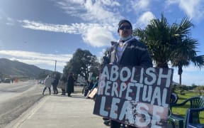 Pryor Whakataka-Brightwell holds his home-made sign in Tokomaru Bay on Saturday, sending a clear message over leasing arrangements which have effectively locked Māori land owners out of their own land.