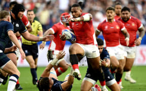 Tonga's right wing Solomone Kata (C) runs with the ball during the France 2023 Rugby World Cup Pool B match between Scotland and Tonga at Stade de Nice in Nice, southern France on September 24, 2023. (Photo by CHRISTOPHE SIMON / AFP)