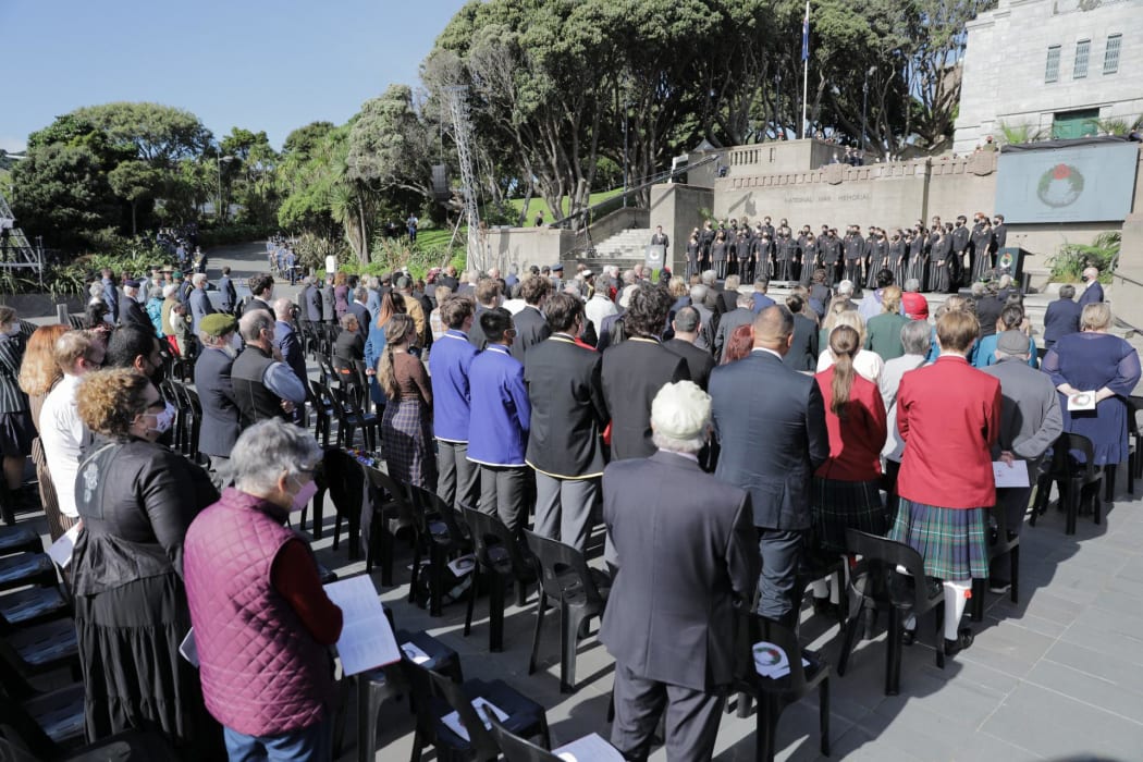 People stand during the National Commemoration Service at Pukeahu National War Memorial in Wellington.