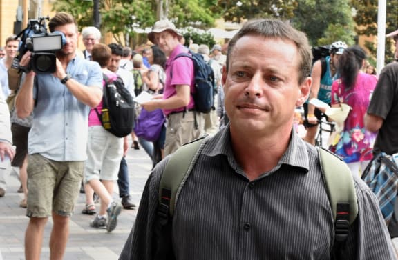 Former Australian Guantanamo Bay inmate David Hicks (R) leaves following his talks with the media at Circular Quay in Sydney on February 19, 2015.