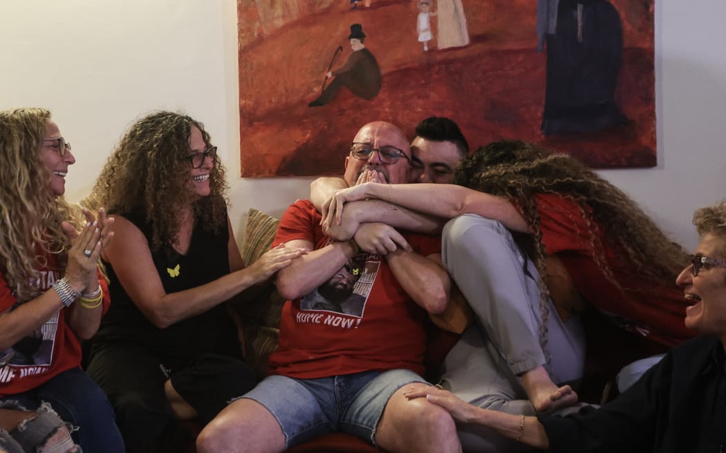 Family and friends of Israeli hostage Eitan Horn react to the news of his release at their house in the central Israeli city of Rosh Haayin on October 13, 2025.. Hamas handed over the 20 surviving Israeli hostages on October 13 under a ceasefire agreement, as the US president and other world leaders geared up for a summit on Gaza.