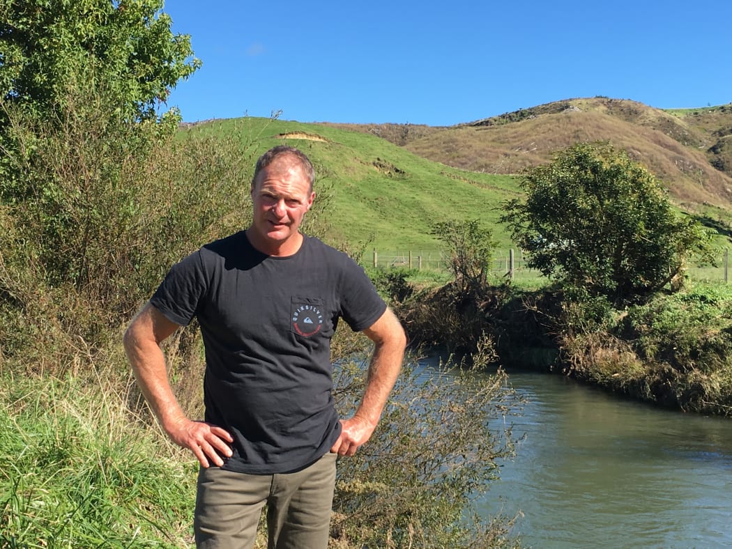 Jared Watson next to the Waiotahe River on his farm.