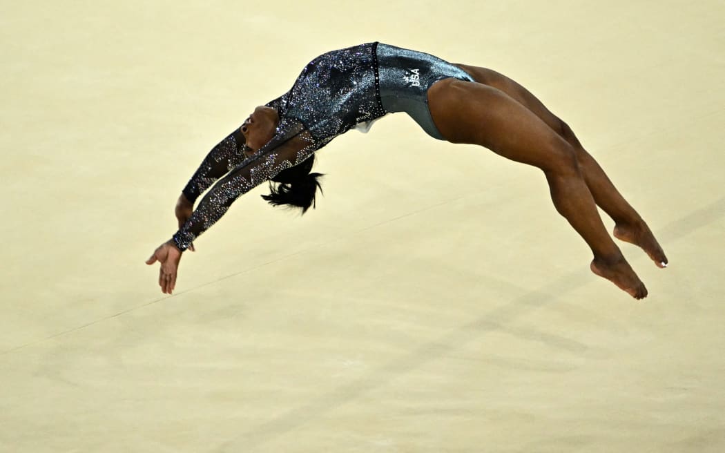 US' Simone Biles competes in the floor exercise event of the artistic gymnastics women's qualification during the Paris 2024 Olympic Games at the Bercy Arena in Paris, on July 28, 2024. (Photo by Lionel BONAVENTURE / AFP)