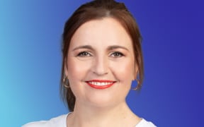 Charlotte Ryan smiles wearing bright red lipstick and a Kate Sylvester T-shirt, text reads "Music 101 Interviews" . Bright blue background.