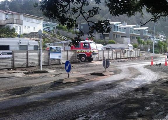 A fire truck pumps water from a Waihi Beach property.