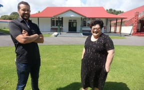 Ānaru White and Wikitoria Michalanney in front of Tama Tāne whare.