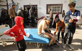 Palestinians receive medical care at Kamal Edwan Hospital in Beit Lahia, in the northern Gaza Strip, on 29 February, 2024, after Israeli soldiers allegedly opened fire at Gaza residents who rushed towards trucks loaded with humanitarian aid amid ongoing battles between Israel and the militant Hamas group. A Gaza emergency doctor said on 29 February that Israeli forces shot dead at least 50 people who rushed towards trucks loaded with humanitarian aid for Gaza City residents. The Israeli army said it was 'checking' the reports on the incident, while the United Nations' humanitarian office OCHA said it was 'familiar with the reports'.