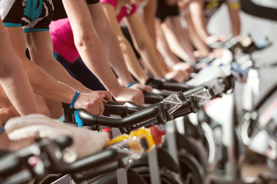 gym detail shot - people cycling; spinning class