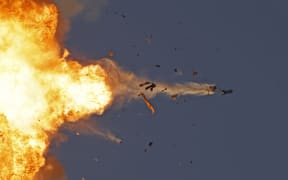 This photo taken from a position in northern Israel shows a Hezbollah UAV intercepted by Israeli air forces over north Israel on August 25, 2024. The Israeli military announced early August 25, 2024 that it was conducting pre-emptive strikes in Lebanon after detecting preparations for "large-scale" attacks by the Iran-backed militant group Hezbollah. Hezbollah said August 25, 2024 it had launched more than 320 rockets at Israel overnight, targeting a string of military positions, even as Israel's military said it was carrying out pre-emptive strikes against the group. (Photo by Jalaa MAREY / AFP)