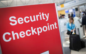 A sign directs travellers to a security checkpoint staffed by Transportation Security Administration (TSA) workers at O'Hare Airport in Chicago, Illinois in June 2015.