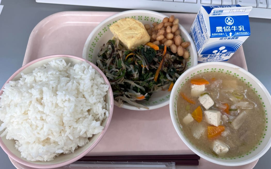 A meal from Kyuushoku (the Japanese school lunch programme), featuring tofu miso soup, rice, vegetables and nato beans.