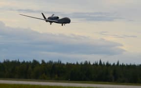 A RQ-4 Global Hawk unmanned surveillance drone lands on August 16, 2018, at Eielson Air Force Base, Alaska.