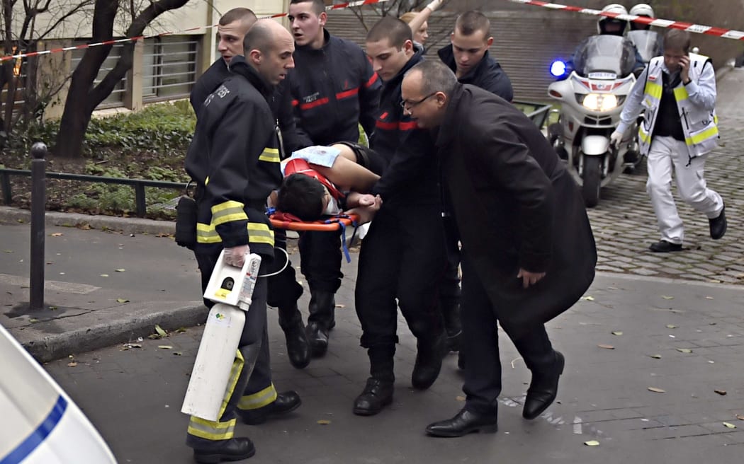 A victim is taken away on a stretcher.