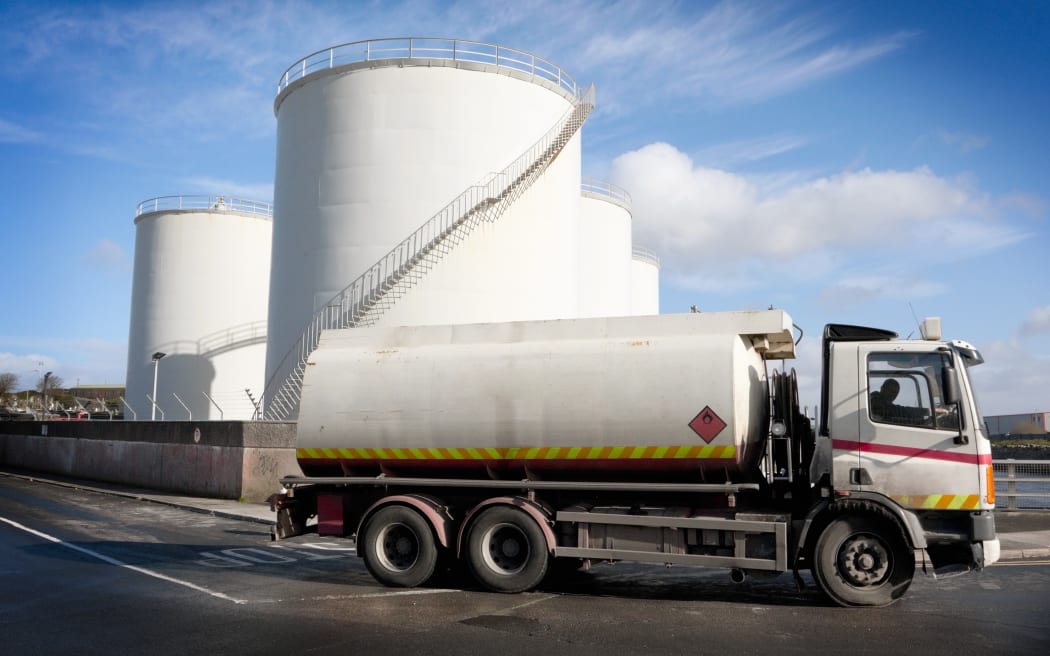 A truck with a fuel tank at an industrial storage site.