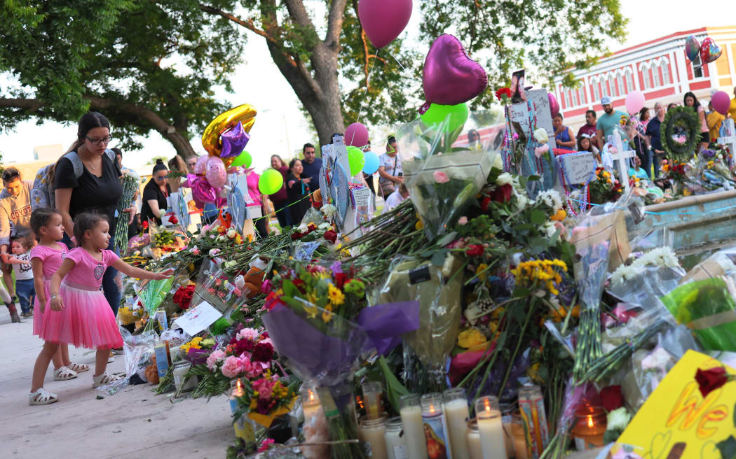 People in Uvalde visit memorials for victims of the May 24th mass shooting at Robb Elementary School, where 19 children and two teachers were killed.