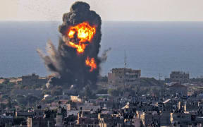 Smoke billows from an explosion following an Israeli air strike in Rafah in the southern Gaza Strip on 13 May 2021.