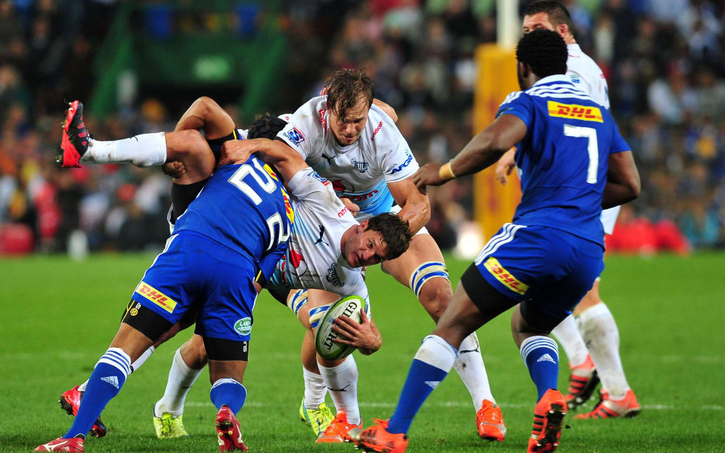 Piet van Syl of the Bulls is tackled by Kurt Coleman of the Stormers