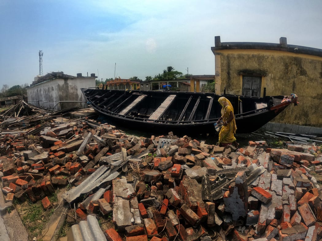A boat hits a destroyed house caused by Cyclone Yaas, in West Bengal, India on 2 July, 2021.