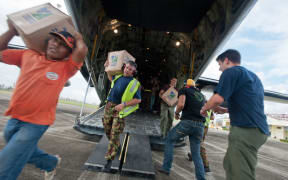 Aid is unloaded from a C-130 Hercules.