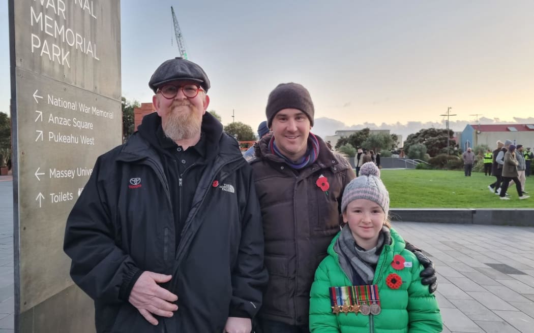 This is Wayne Morris, Craig Rodger and his daughter Tessa (8), it's Tessas first dawn service and she's wearing her great grandfather's WW2 medals. They met Wayne, who's from the UK and is involved with the Poppy Appeal there. He makes special poppy pins out of Lego - which he gifted to Tessa and several more kids this morning