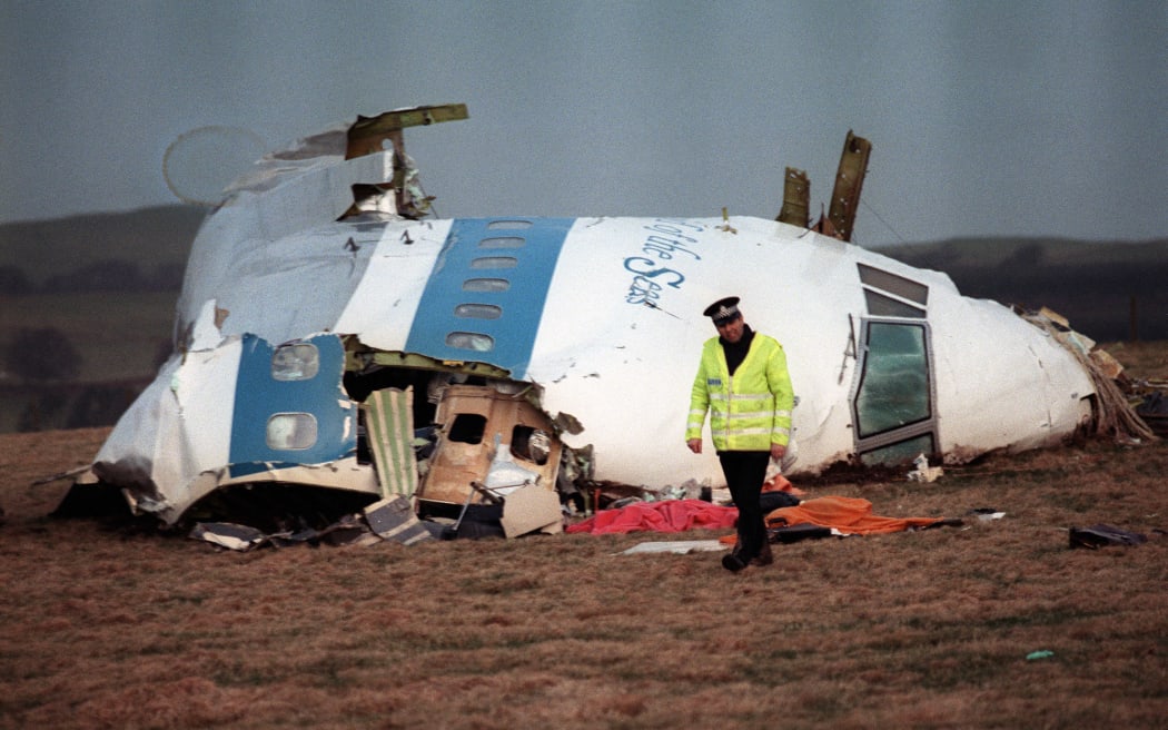 A policeman walks away from the cockpit of the Pan Am airline plan that exploded and crashed over Lockerbie, Scotland, 22 December, 1988.