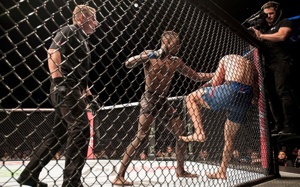 Israel Adesanya fighting Rob Wilkinson at UFC 221