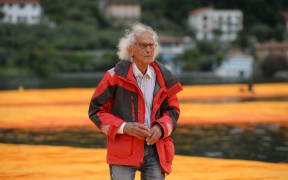 Artist Christo Vladimirov Javacheff walks on his monumental installation "The Floating Piers" he created with Jeanne-Claude at the lake Iseo, northern Italy, on June 16, 2016.