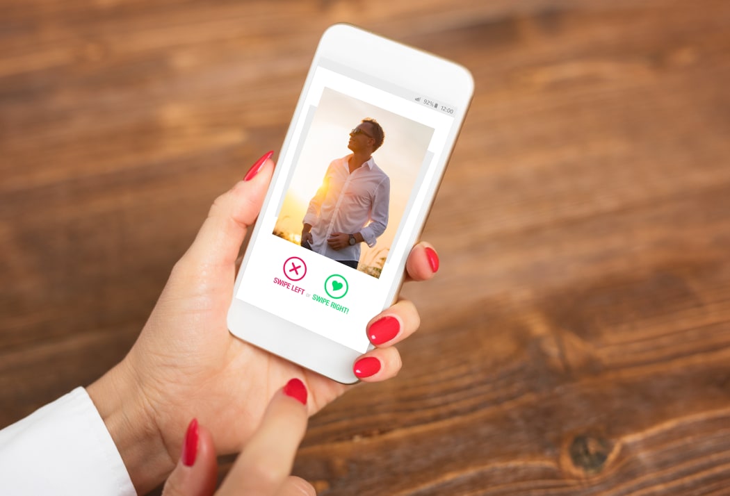 woman looks at online dating profile