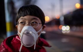 A child in Beijing, wearing a protective mask, 29 Janaury.