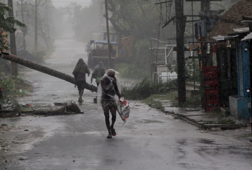 People at the Chandabali and Dhamra area of Bhadrak district, 160km from the eastern Indian state Odisha's capital city as Cyclone Amphan crosses the Bay of Bengal's eastern coast.