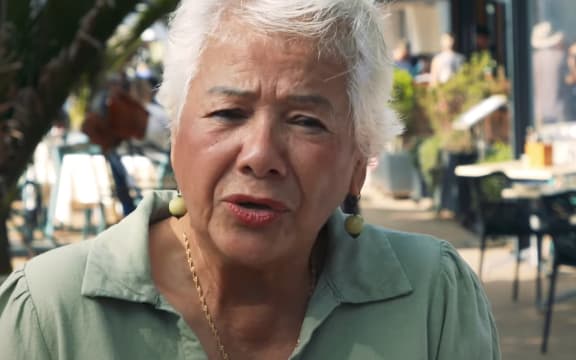 An older woman in a green shirt speaking to Checkpoint about coffee