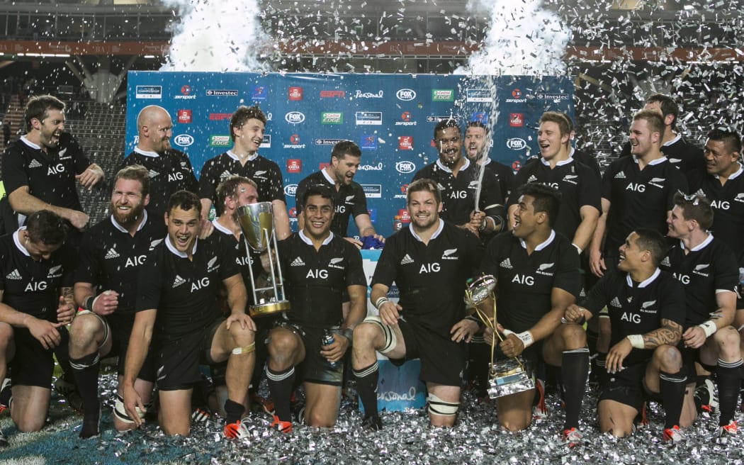 The All Blacks celebrate with the trophy