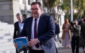 Finance minister Grant Robertson showing the cover of Budget 2023 the day before its reveal