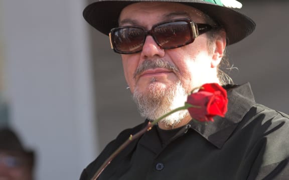 portrait of musician Dr John with rose