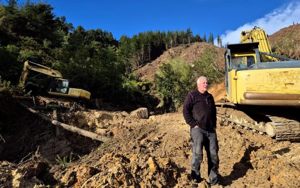 Parrish Hurley next to what was once a "trickle" of a stream.