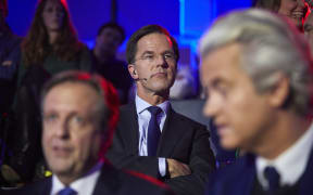Netherland's Prime Minister Mark Rutte sits behind Alexander Pechtold of Dutch Democratic 66, left, and eert Wilders of the Freedom Party, right, ahead of a televised election debate.